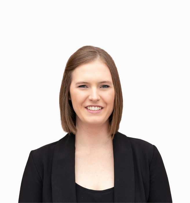 Professional portrait in front of red brick wall