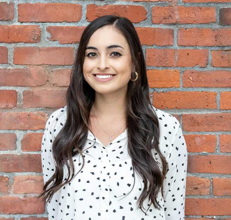 Professional portrait in front of red brick wall